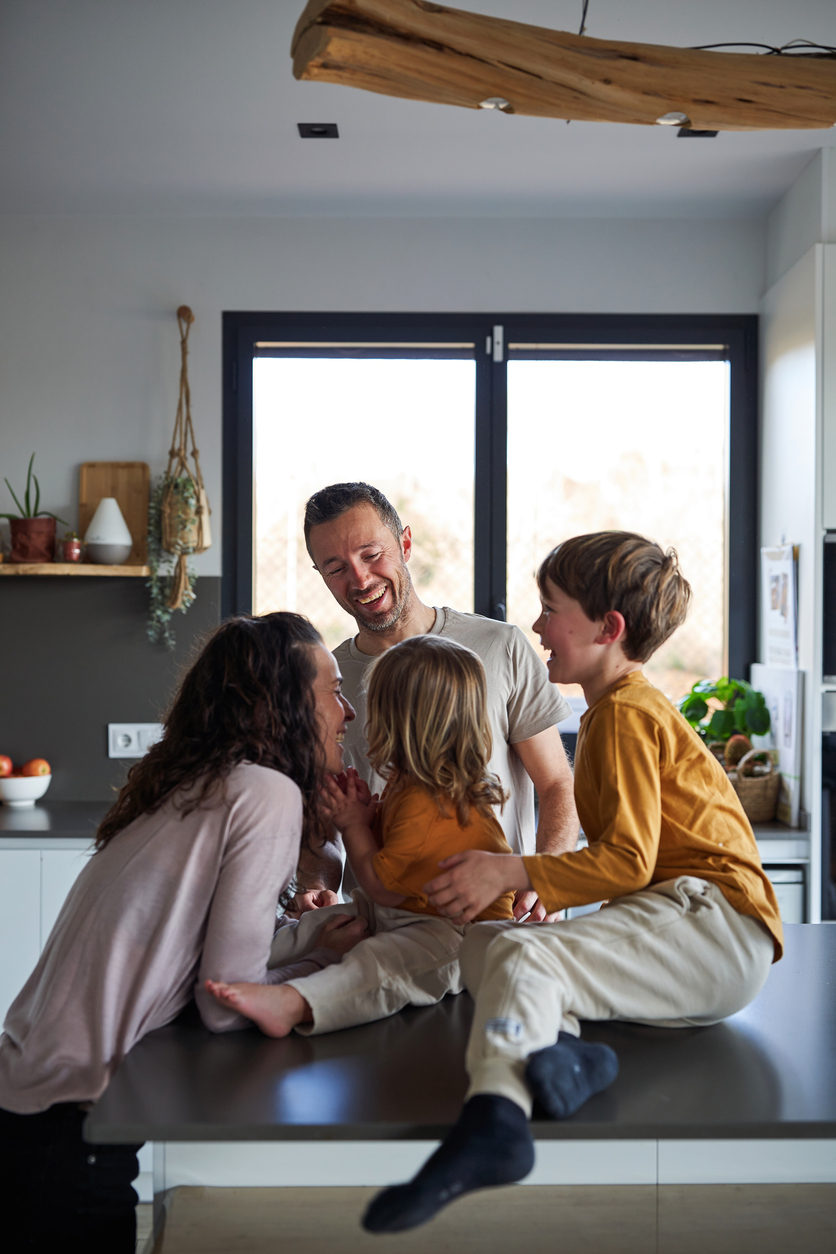 Happy young family loving and caring, being playful with their children Happy young family loving and caring, being playful with their children